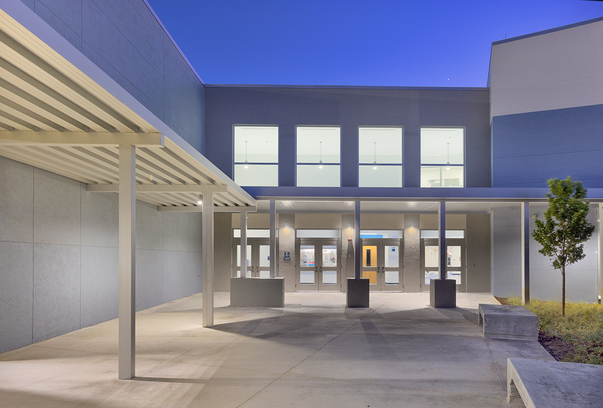 Architectural dusk entrance view of the Plumosa School of the Arts in Delray Beach. FL.
